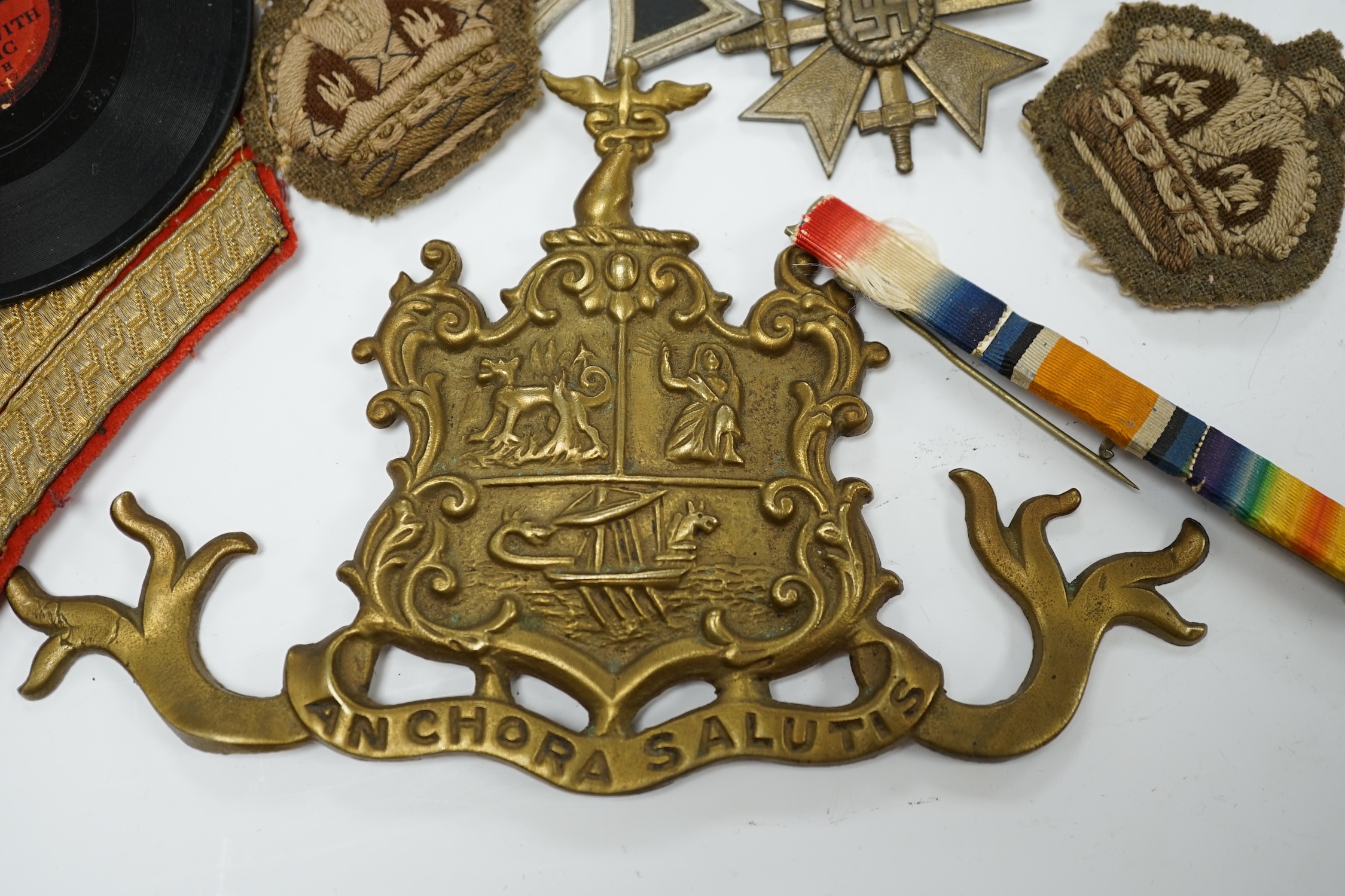 Three WWII German medals; a Second Class Iron Cross and two Merit Crosses, together with a brass naval related crest, a Metropolitan whistle, sergeant’s cloth titles, and other ephemera. Condition - fair